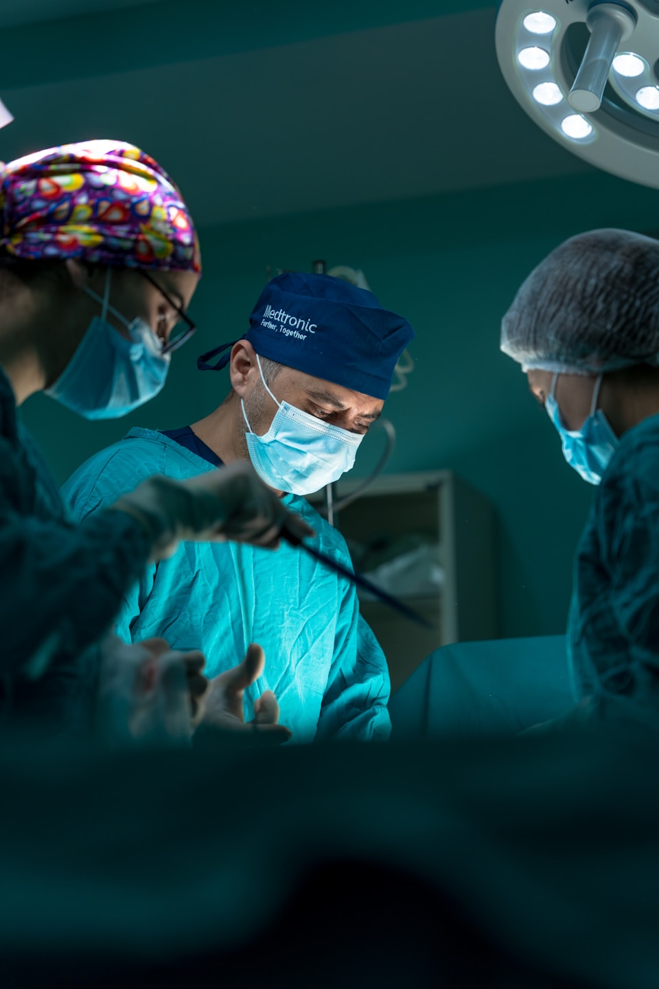 Surgeons performing advanced procedure in operating room